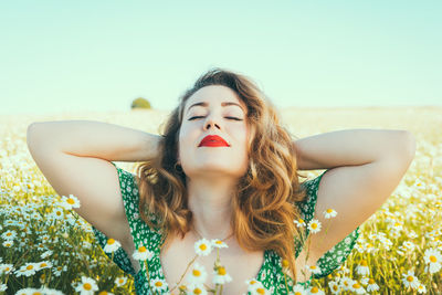 Portrait of beautiful young woman against white wall