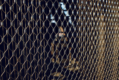 Full frame shot of chainlink fence at night