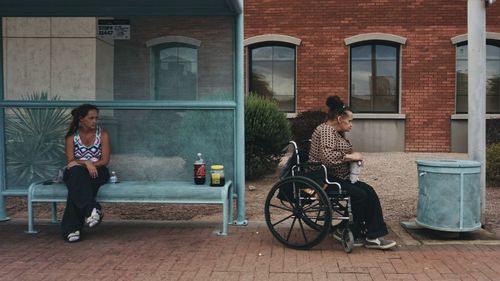 Woman sitting outside building