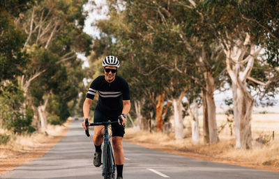 Man riding bicycle on road