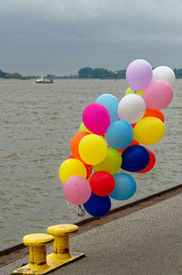 Multi colored balloons on quay of elbe river