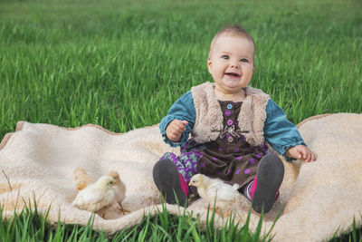 Portrait of cute girl with dog on field