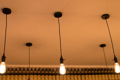 Illuminated light bulbs hanging from ceiling