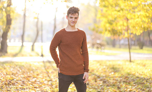 Portrait of young man standing on land during autumn