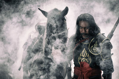 Man in warrior costume with horse