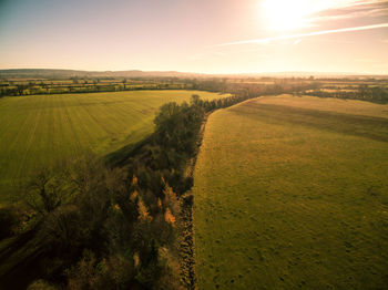 Scenic view of field against sky during sunset