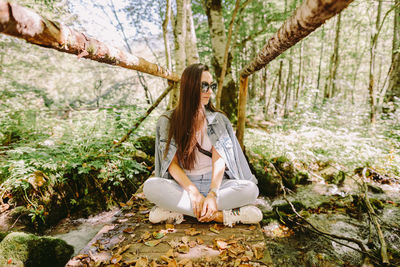 Woman sitting in forest