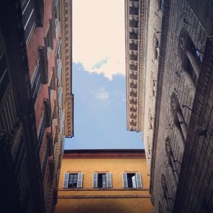 Low angle view of buildings in town against sky