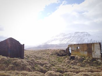 Scenic view of field against cloudy sky