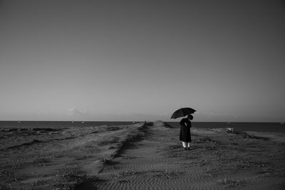 Full length of man on beach against sky