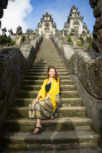 Portrait of woman sitting on staircase