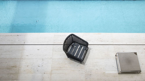 High angle view of chair on swimming pool