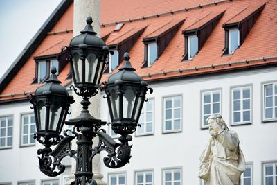 Low angle view of statue against building in city