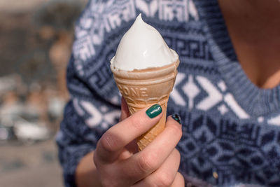 Cropped image of woman holding ice cream cone