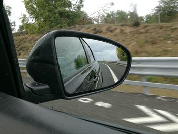 Reflection of car on side-view mirror