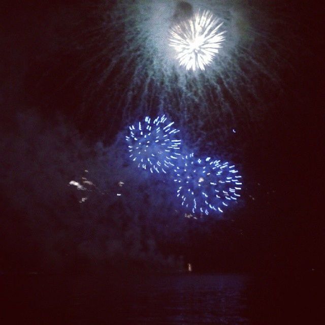 firework display, illuminated, celebration, night, exploding, long exposure, sparks, firework - man made object, glowing, motion, arts culture and entertainment, event, firework, blurred motion, entertainment, multi colored, water, celebration event, low angle view, fire - natural phenomenon