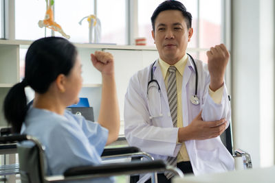 Portrait of businessman using mobile phone in office