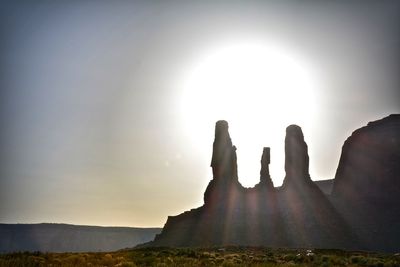 Silhouette rock formations against sky