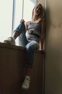 Young woman sitting on floor