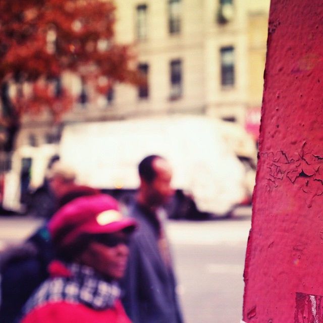 lifestyles, focus on foreground, built structure, leisure activity, red, building exterior, men, architecture, person, love, selective focus, street, togetherness, day, city, outdoors, rear view