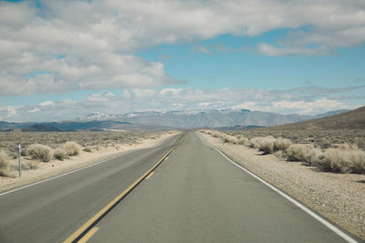 Road by landscape against sky