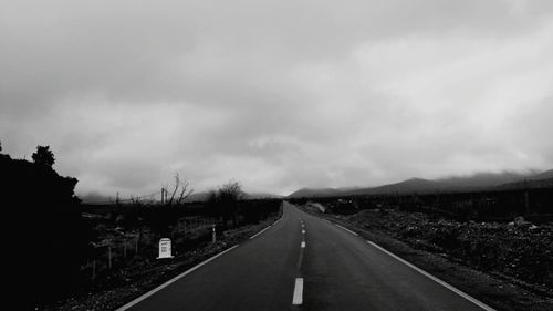 Road by landscape against sky