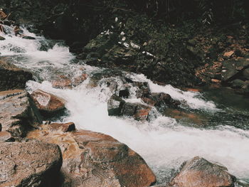 High angle view of water flowing through rocks