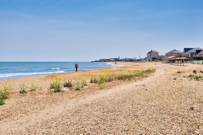 Man standing on beach against sky