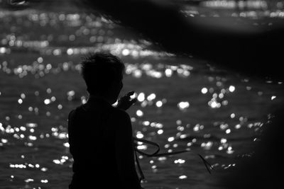 Defocused image of illuminated man at night