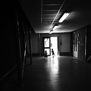 Full length of illuminated woman in corridor