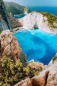 Scenic view of rocky cliff by sea