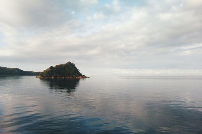 Scenic view of sea against cloudy sky