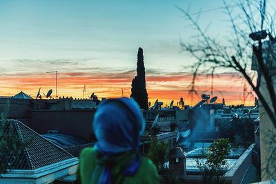 Man photographing cityscape at sunset
