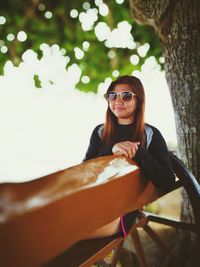 Portrait of smiling young woman sitting outdoors