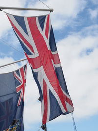 Low angle view of american flag against sky