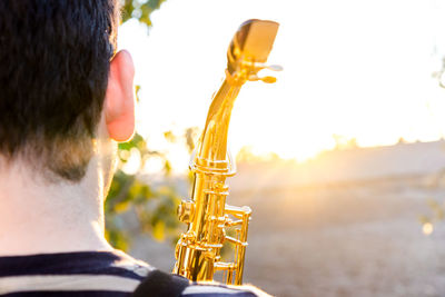 Side view of young man playing guitar