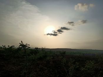 Scenic view of field against sky during sunset