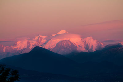 Scenic view of mountains against sky at sunset