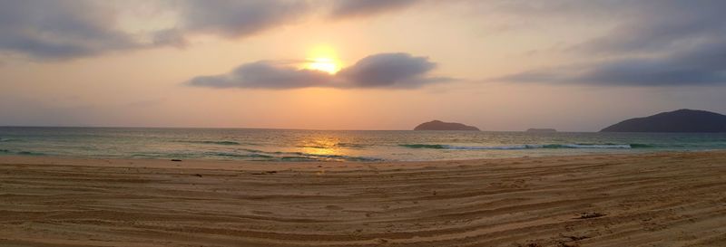 Scenic view of beach against sky during sunset