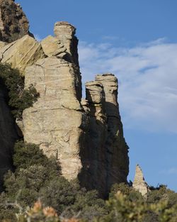 Low angle view of rock formations against sky