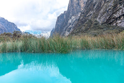 Scenic view of lake and mountains against sky