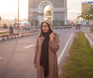 Portrait of woman standing in city