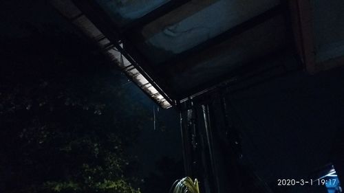 Low angle view of illuminated abandoned building at night