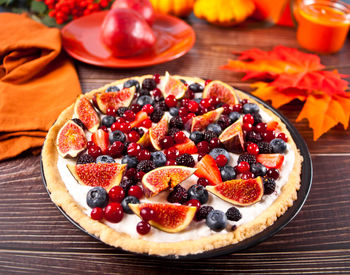 Fresh baked homemade fig and berries tart with mascarpone cheese