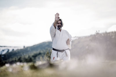 Senior man practicing karate outdoors