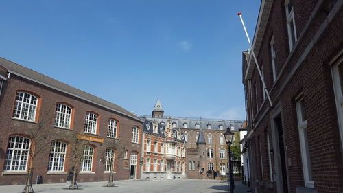 Street amidst buildings against sky