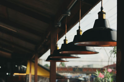 Low angle view of illuminated pendant light in building