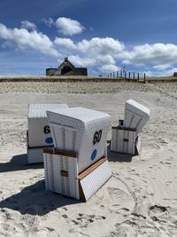 Hooded beach chairs on sand