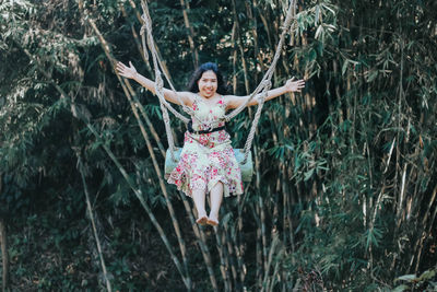 Full length of woman with arms raised