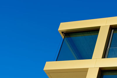 Low angle view of building against clear blue sky